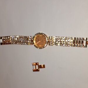 Geneva goldtone watch with crystals.